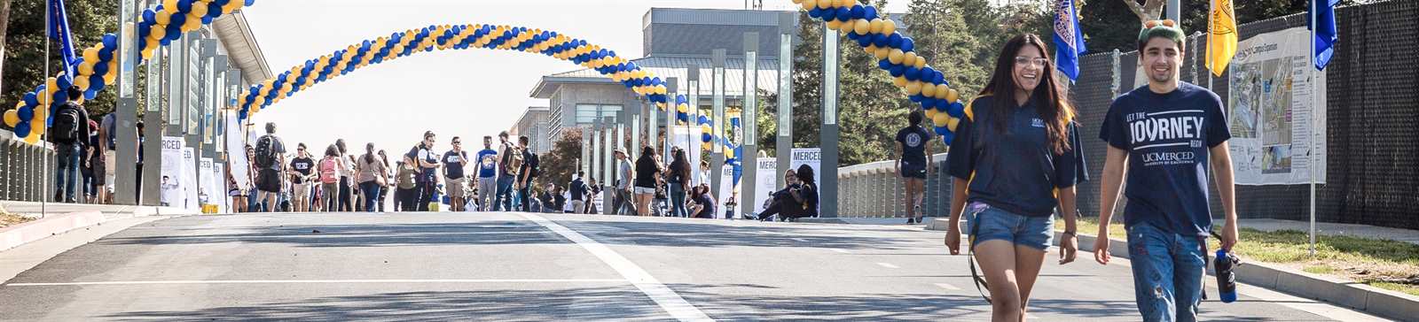 students crossing scholars bridge